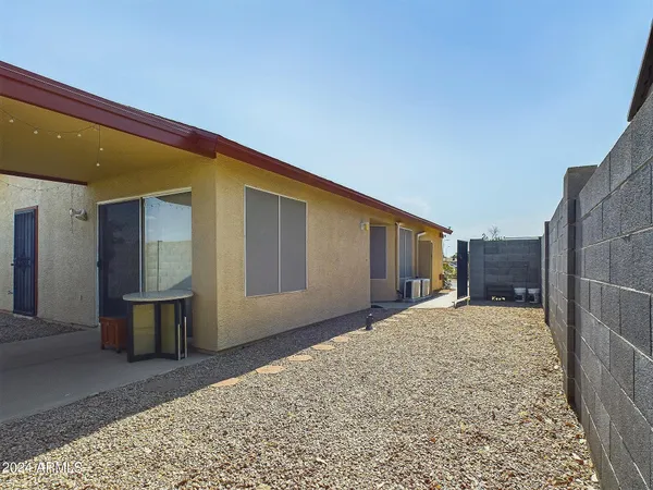 a view of a house with a backyard