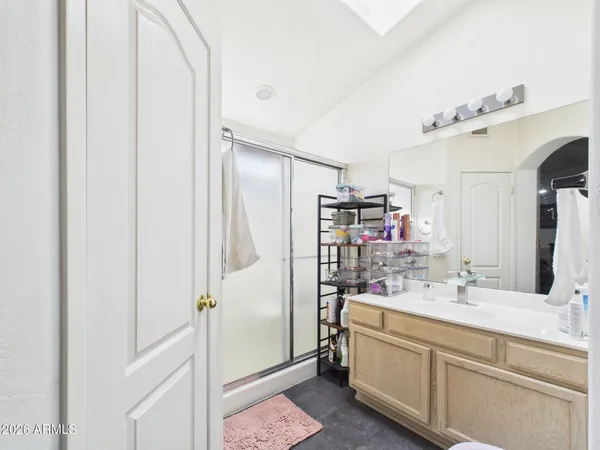 a bathroom with a double vanity sink mirror and shower