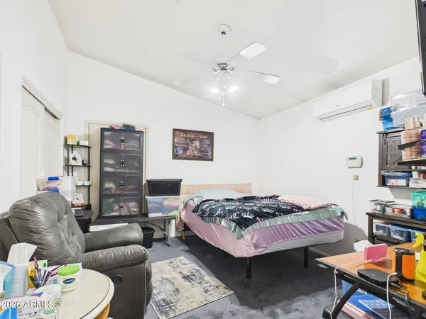 a bedroom with furniture and a wooden floor