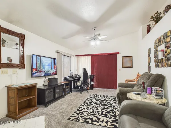 a living room with furniture and a lamp