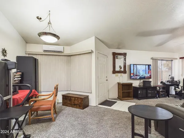 a living room with furniture a fireplace and a table
