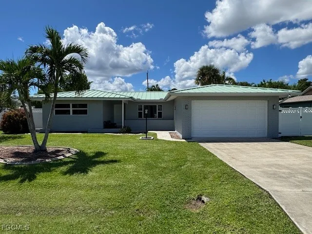 a front view of a house with a garden and yard