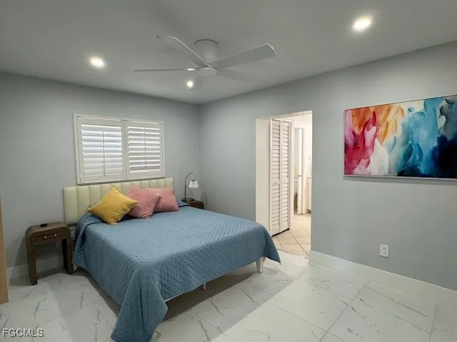 a bedroom with a bed and a painting