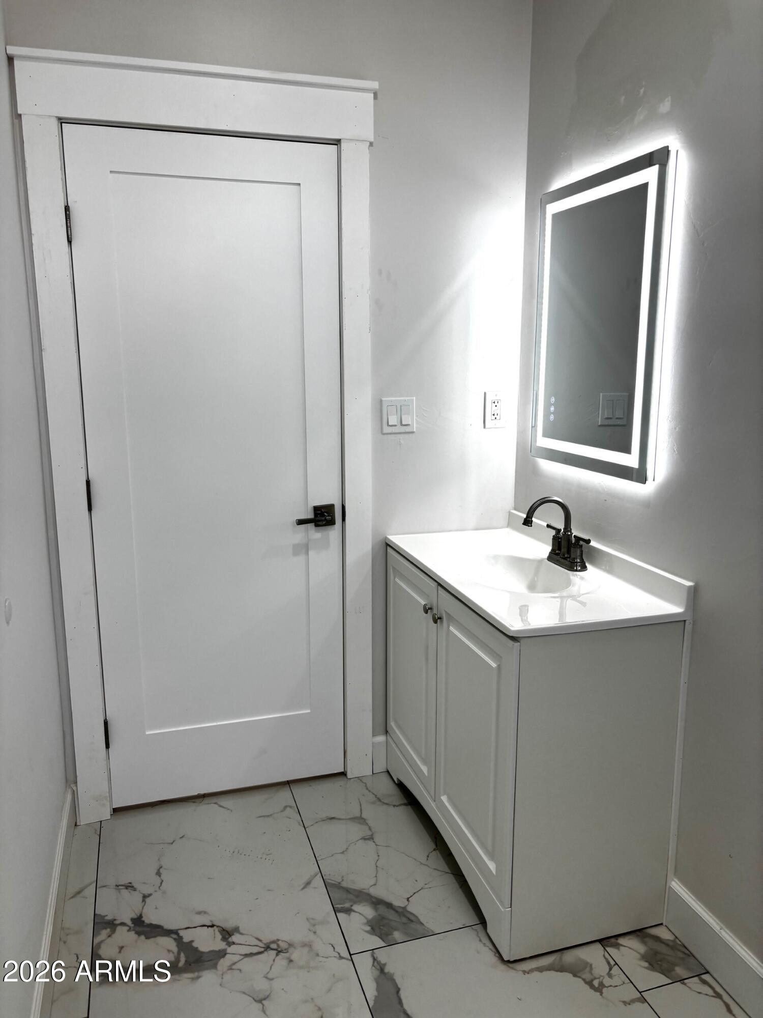 4000 Santa Fe Avenue Douglas, AZ 85607 - Photo 12 of 16 a bathroom with a sink a mirror and a shower