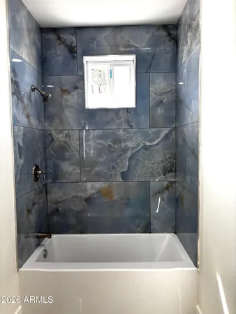 a bath tub sitting next to a white sink