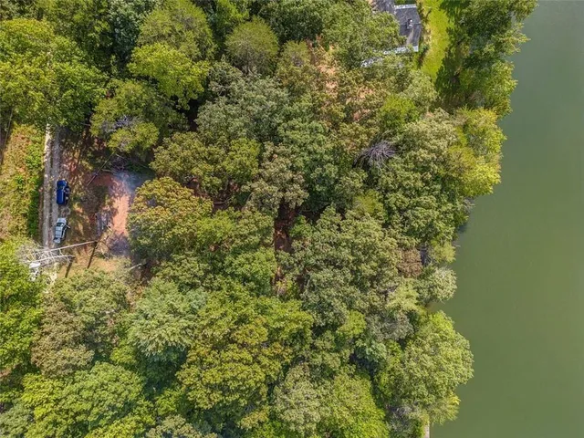 an aerial view of residential house with outdoor space and lake view
