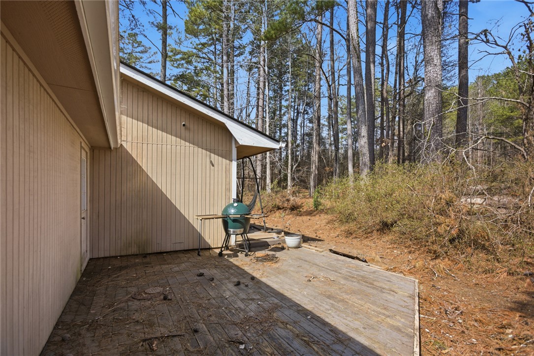 308 Wildwood Road Walhalla, SC 29691 - Photo 17 of 23 This spacious wooden deck offers serene outdoor living amidst a natural, wooded setting.