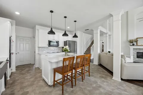a kitchen with kitchen island granite countertop a table and chairs