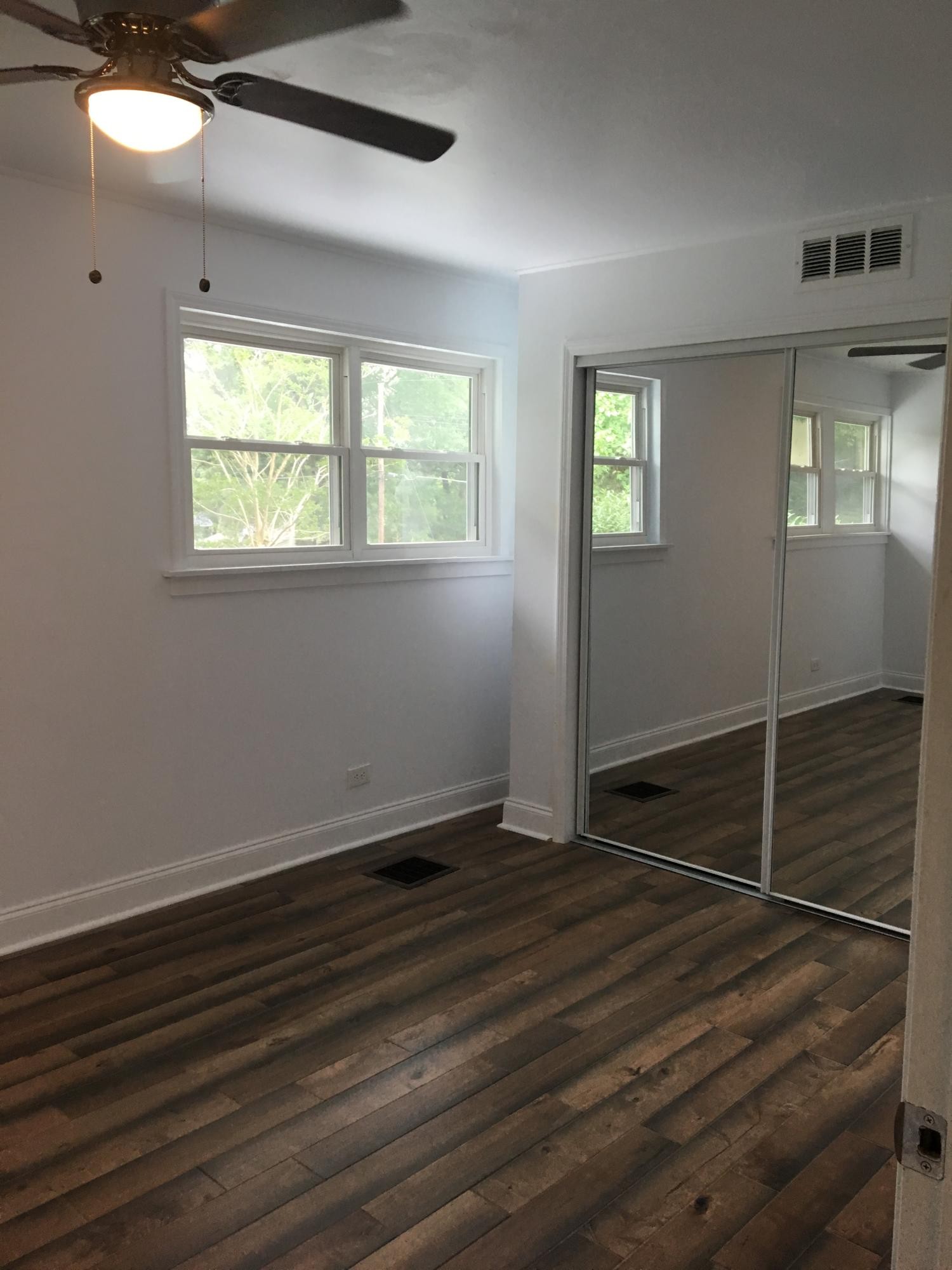 107 Pembroke Road Oak Ridge, TN 37830 - Photo 10 of 28 an empty room with wooden floor and windows