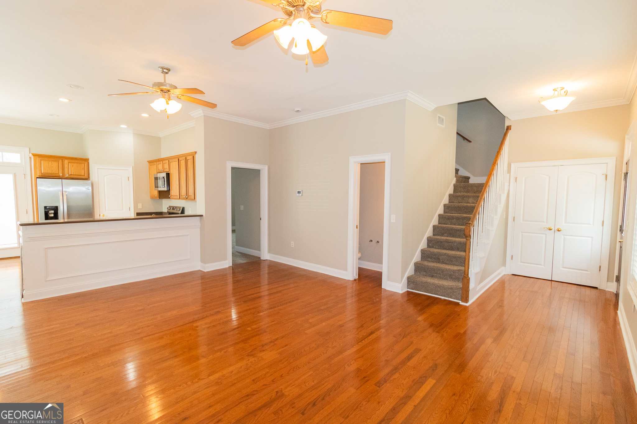 121 Tillman Road, Unit 301 Statesboro, GA 30458 - Photo 3 of 8 a view of a livingroom with wooden floor and a ceiling fan