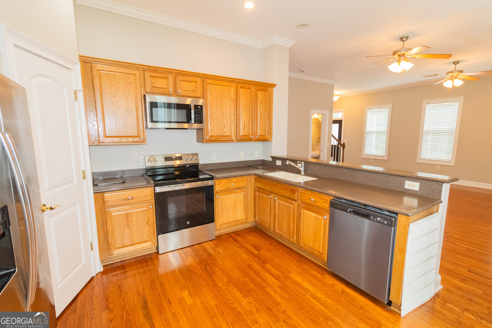 121 Tillman Road, Unit 301 Statesboro, GA 30458 - Photo 4 of 8 a kitchen with stainless steel appliances granite countertop a stove a sink and a refrigerator
