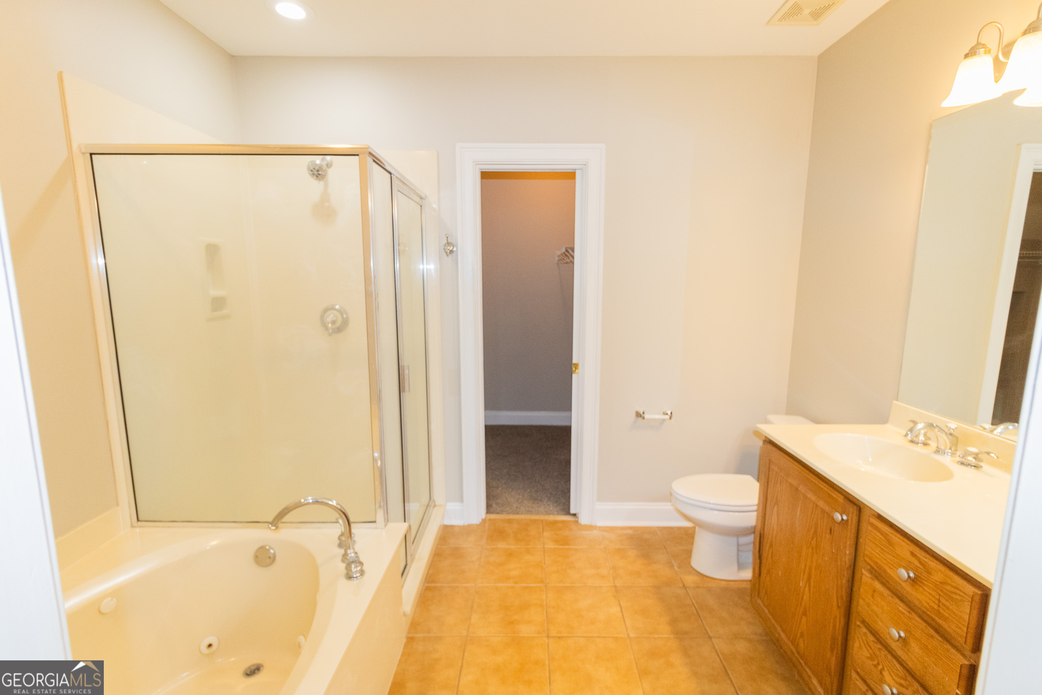 121 Tillman Road, Unit 301 Statesboro, GA 30458 - Photo 7 of 8 a bathroom with a granite countertop sink toilet and shower