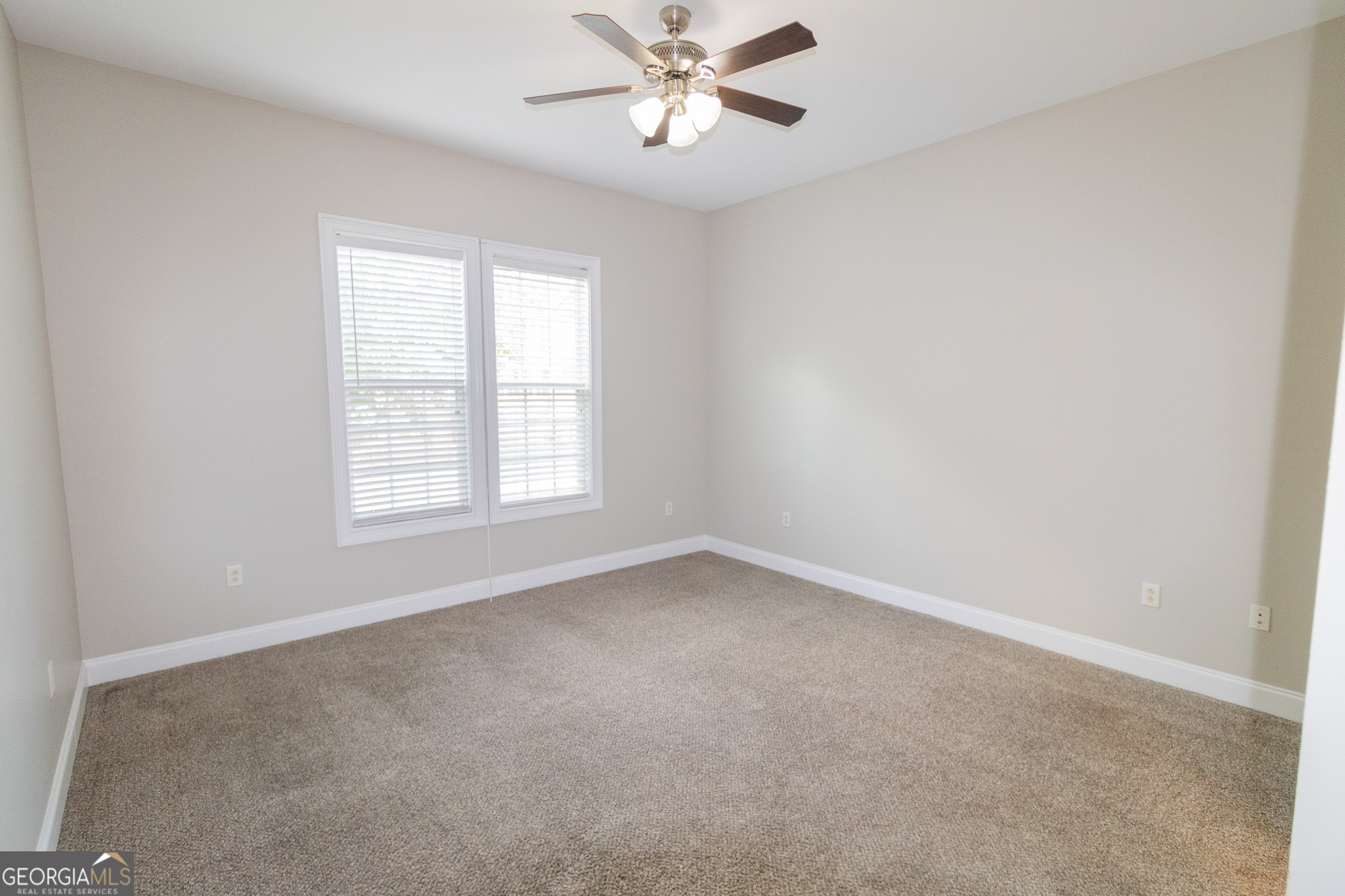 121 Tillman Road, Unit 301 Statesboro, GA 30458 - Photo 8 of 8 an empty room with a window and a fan