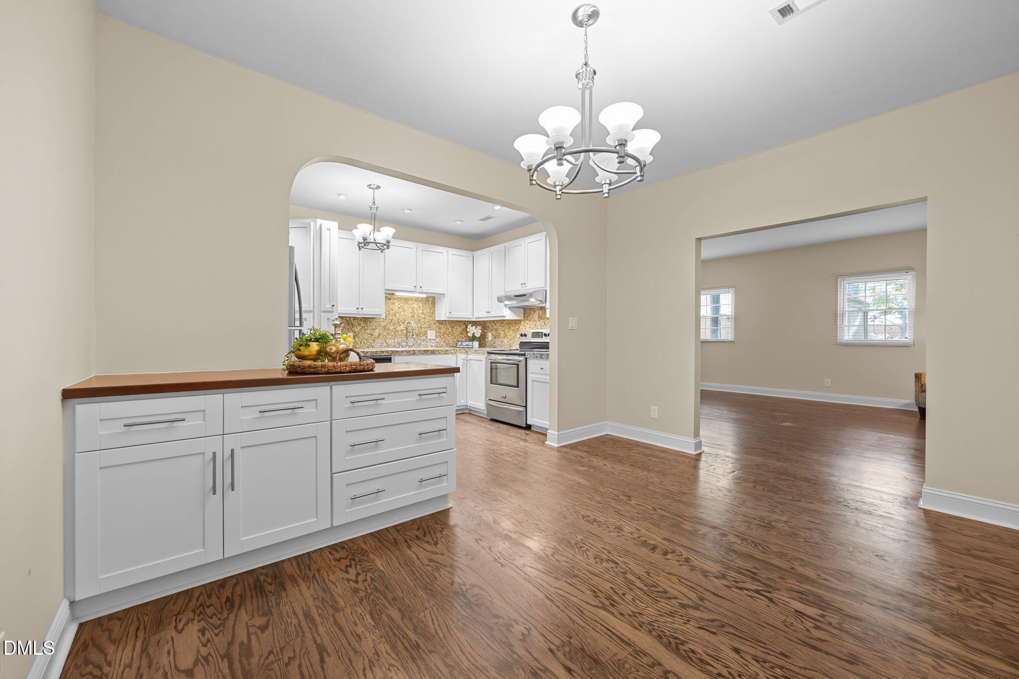 6423 New Market Way Raleigh, NC 27615 - Photo 4 of 33 a kitchen with stainless steel appliances granite countertop a dishwasher a stove cabinets and wooden floor