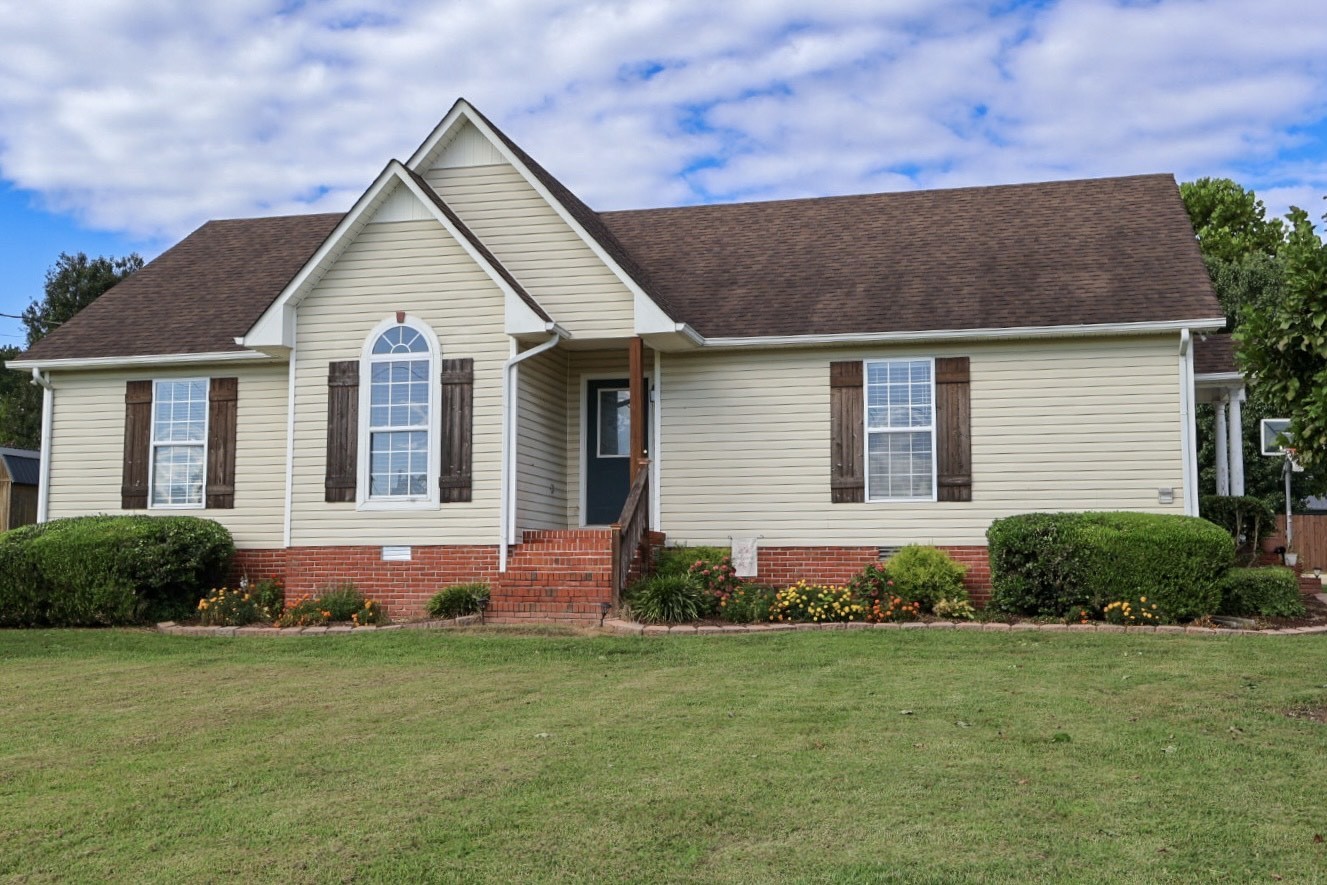 a front view of house with yard and green space