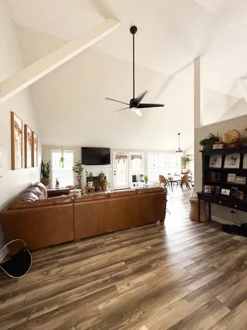 a view of living room with furniture and wooden floor