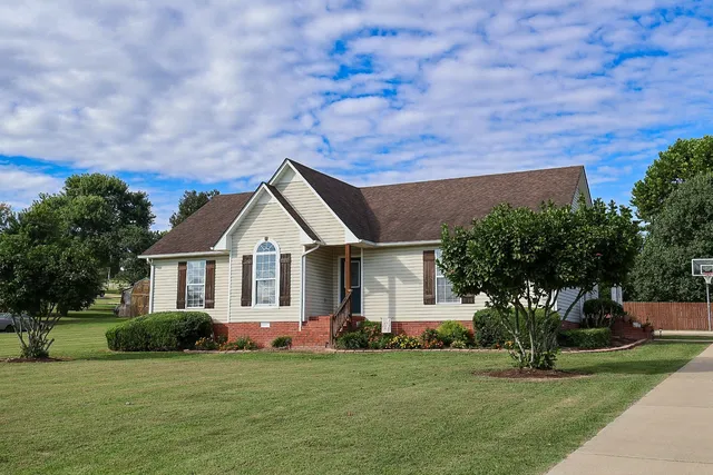 a front view of a house with a garden