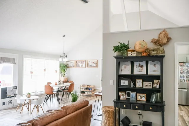 a living room with furniture and a book shelf