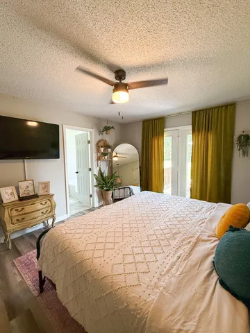 a bedroom with a bed and a large mirror