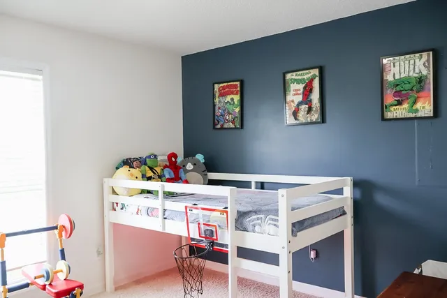 a bedroom with a bed and a window