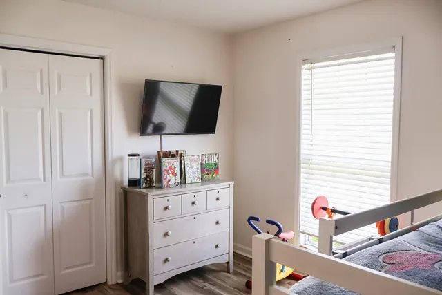 a room with toys and baby crib