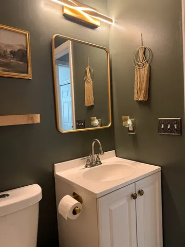 a bedroom with a bed and large windows