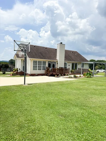 a front view of building with yard and green space