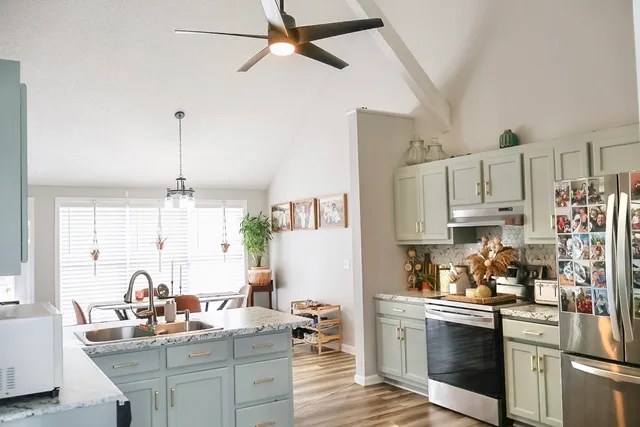 a kitchen with kitchen island white cabinets and refrigerator