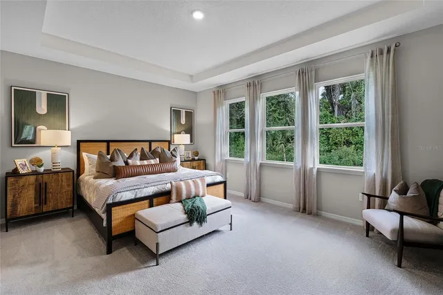 a bedroom with a bed and a couch next to a window