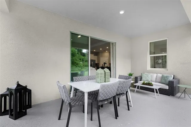 a view of a dining room with furniture and a window