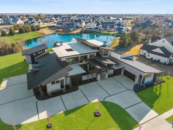 an aerial view of a house with a lake view