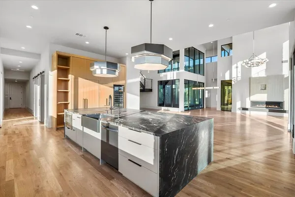 a kitchen with stainless steel appliances granite countertop a stove and a wooden floors