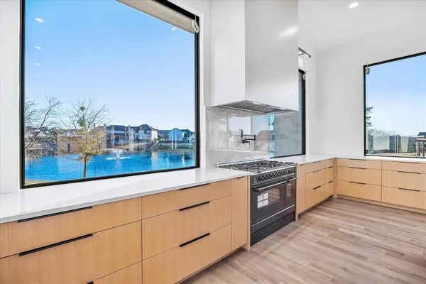 a large kitchen with granite countertop a stove and a sink