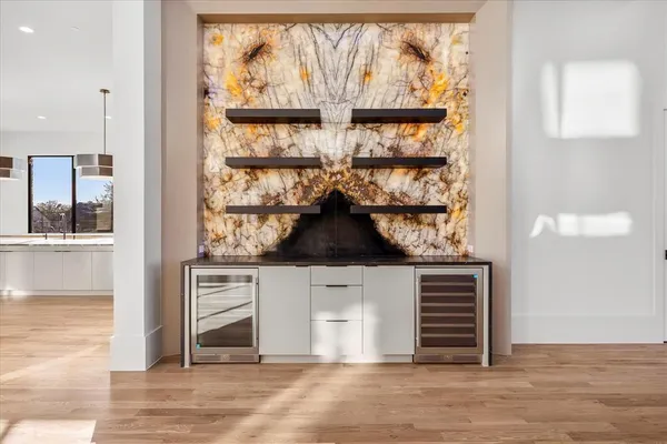 an entryway with wooden floor and cabinet