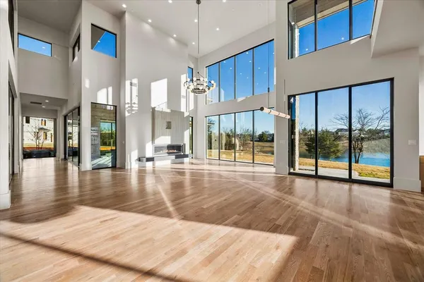 a view of a hall with floor to ceiling window and kitchen
