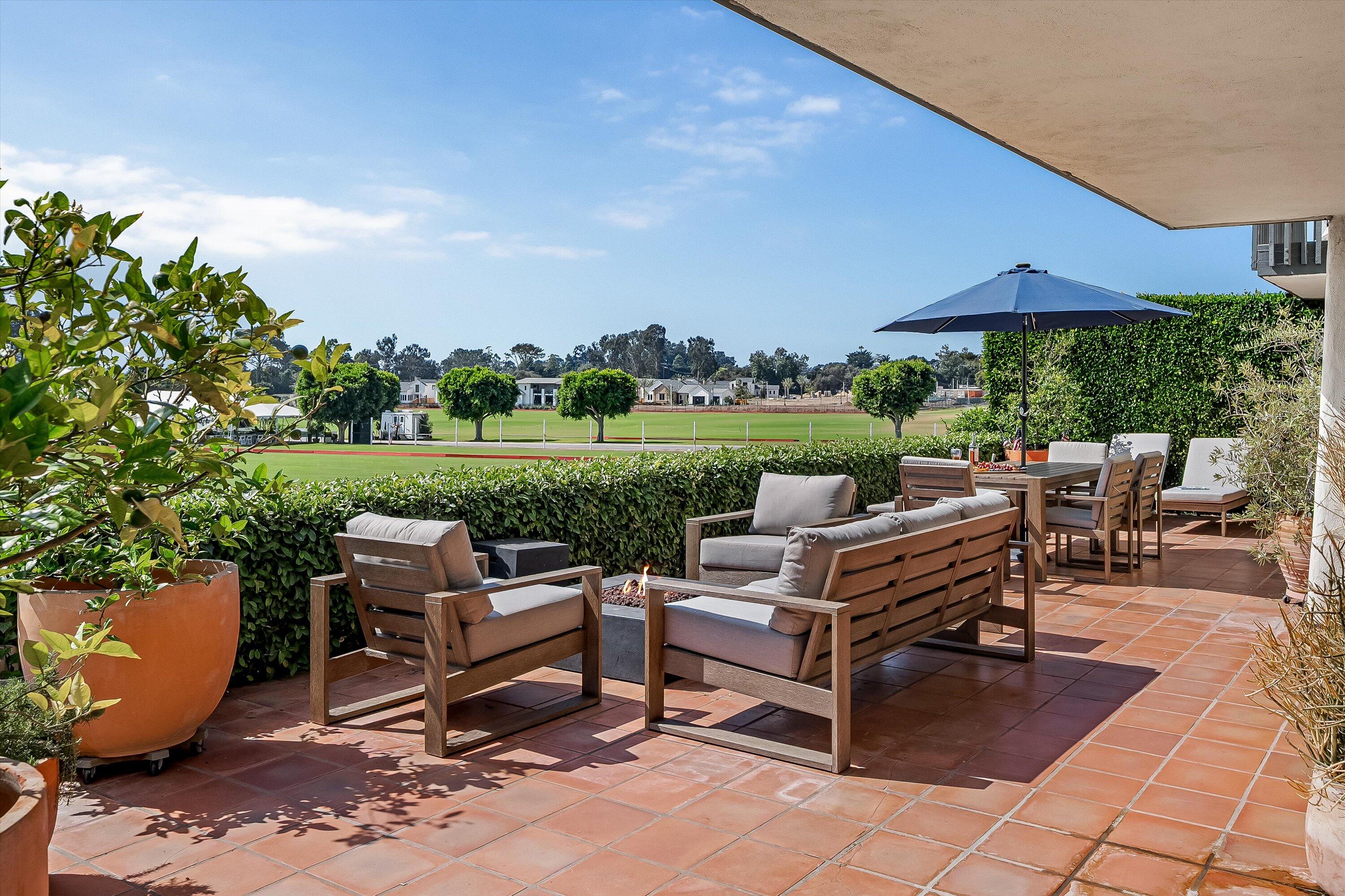 a view of a patio with chairs and a table