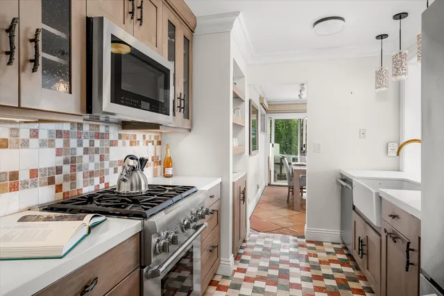 a large white kitchen with a stove a sink and a refrigerator