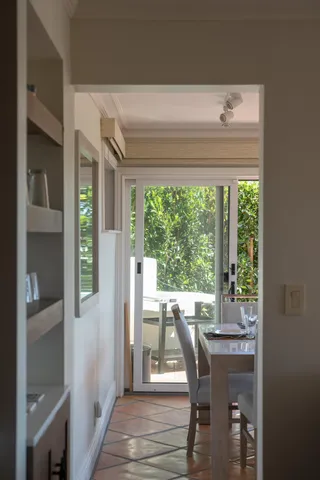 a view of a dining room with furniture large windows and wooden floor