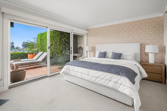 a bedroom with a large bed and a flat tv screen