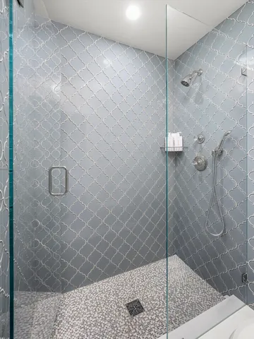 a living room with a couch and a potted plant