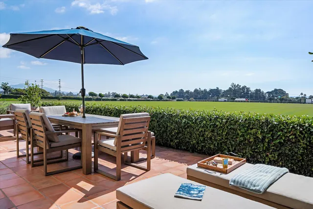 a view of a roof deck with furniture and a yard