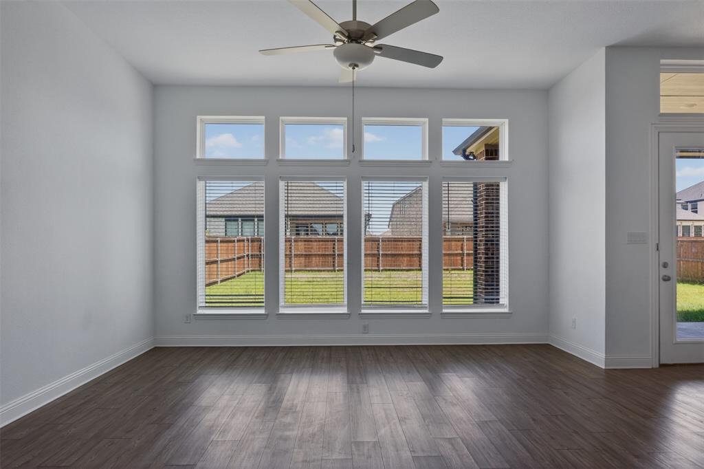 845 Ranchland Road Justin, TX 76247 - Photo 10 of 22 an empty room with wooden floor and windows