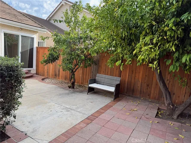 a view of backyard with deck and a large tree