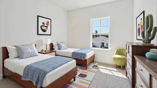 a spacious bedroom with two beds and a window