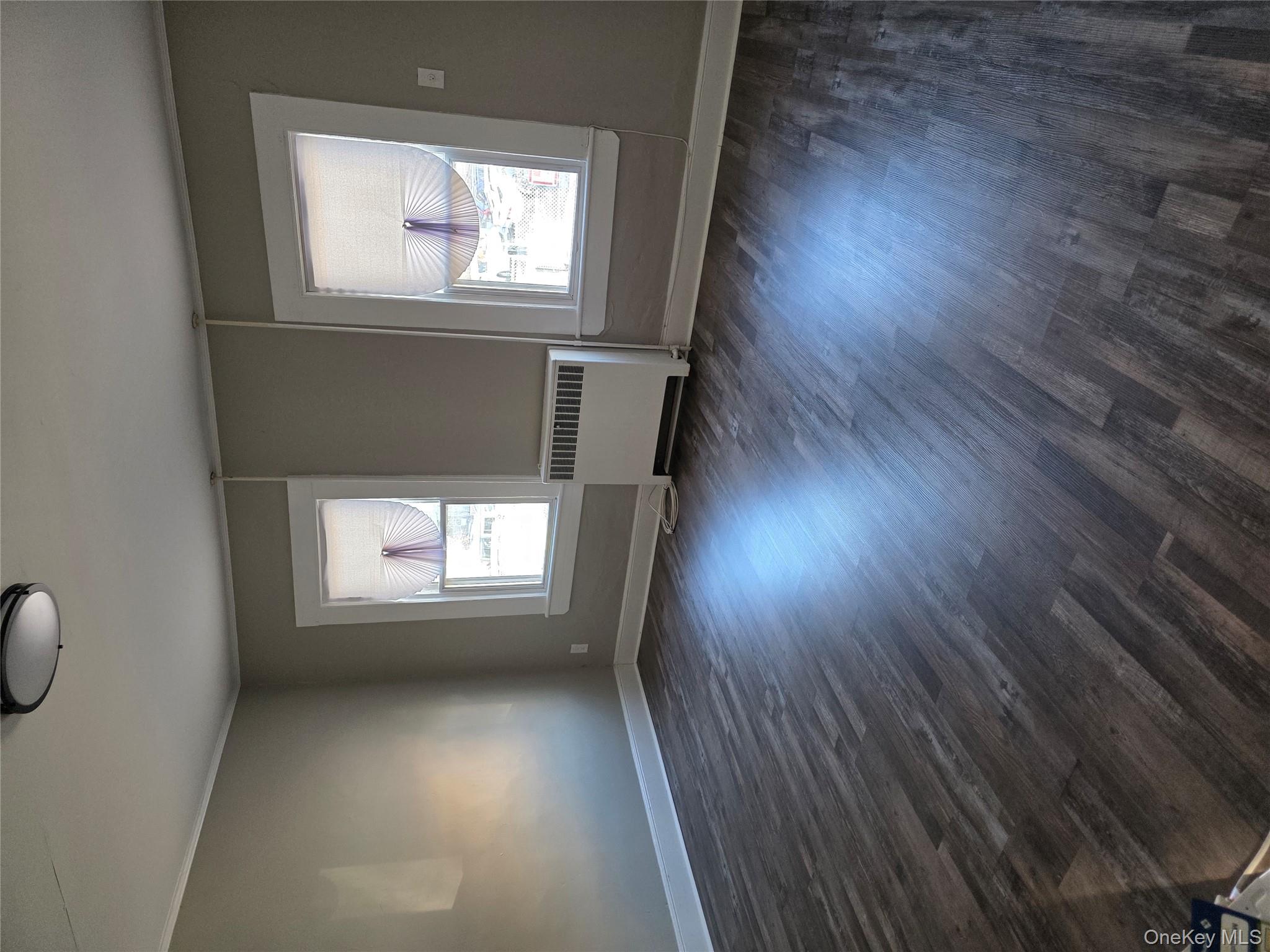 18 Davis Street Poughkeepsie, NY 12601 - Photo 11 of 14 Unfurnished room with radiator heating unit, dark wood-style flooring, and crown molding