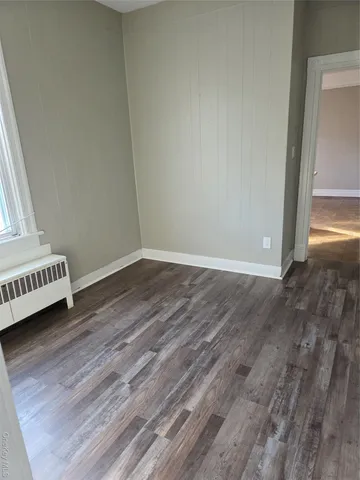 a view of a room with wooden floor and bedroom