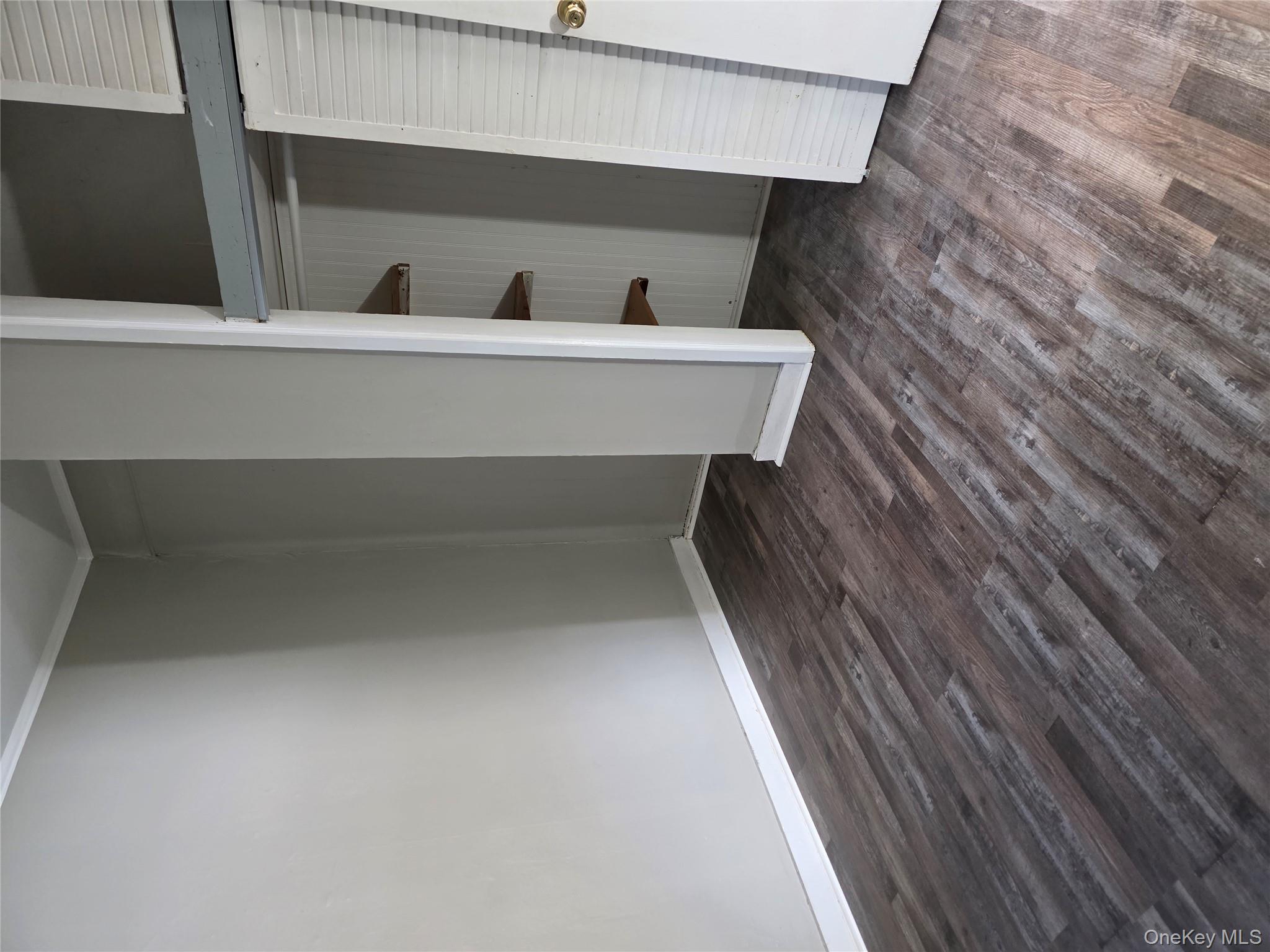 18 Davis Street Poughkeepsie, NY 12601 - Photo 3 of 14 Unfurnished bedroom featuring dark wood-style flooring, a closet, and crown molding