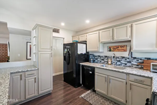 a kitchen with sink a stove and cabinets