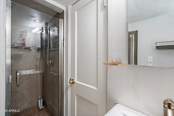 a bathroom with a sink vanity mirror and toilet