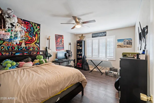 a bathroom with a granite countertop sink vanity mirror and toilet